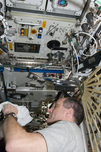 NASA image: Pettit performs an in-flight maintenenace on the PWD in the U.S. Laboratory