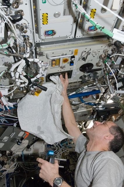 NASA image: Pettit performs an in-flight maintenenace on the PWD in the U.S. Laboratory