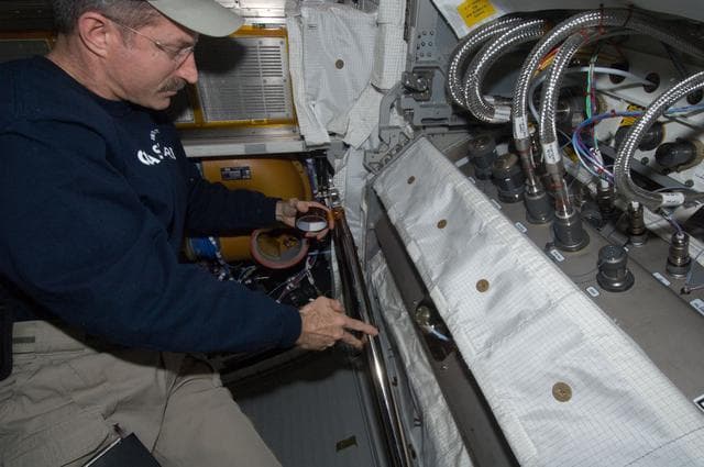 NASA image: Burbank performs the scheduled extensive cleanup of ventilation systems