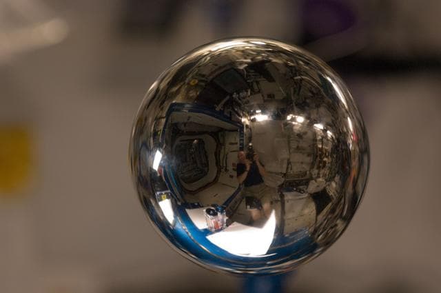 NASA image: Water Bubble revealing a refracted image of ESA Andre Kuipers
