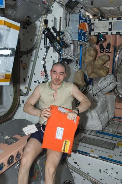 NASA image: Ivanishin holds Ammonia Respirator in the Node 1