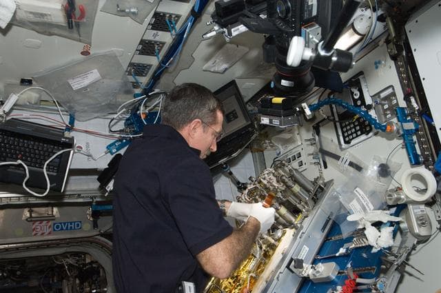 NASA image: Burbank replaces a Catalytic Reactor 2 (CR2)