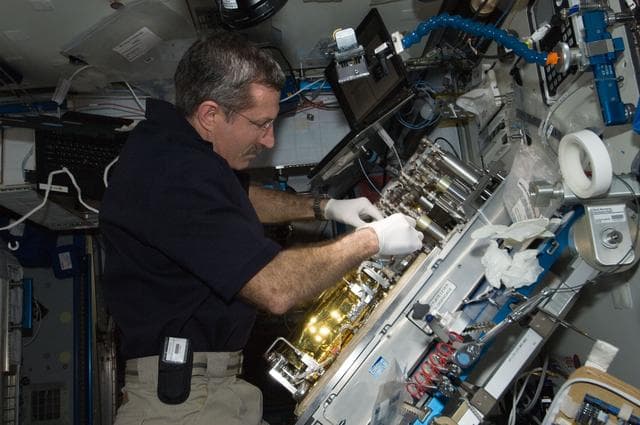 NASA image: Burbank replaces a Catalytic Reactor 2 (CR2)