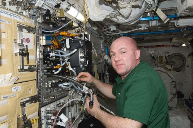 NASA image: Kuipers works to remove the Marangoni Suface Fluid Physics Experiment
