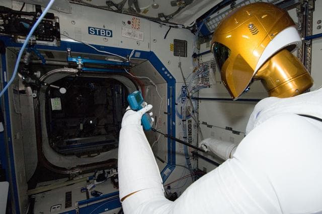NASA image: Robonaut 2 Humanoid Robot holds instrument to measure air velocity