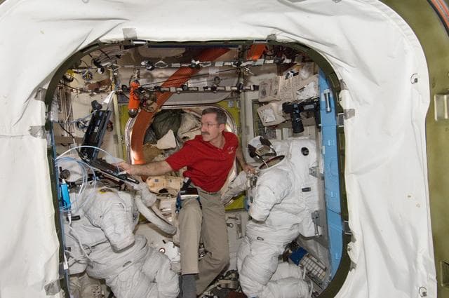 NASA image: Burbank performs routine in-flight maintenance on the EMU
