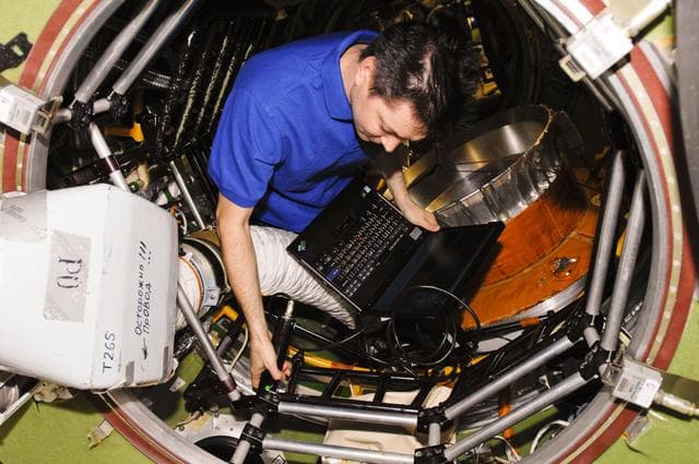 NASA image: Kononenko uses laptop computer in the SM Transfer Compartment