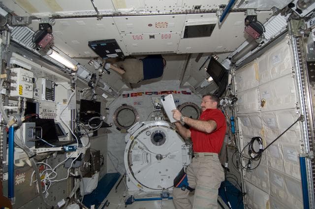 NASA image: Burbank reviews crew procedures in the JPM
