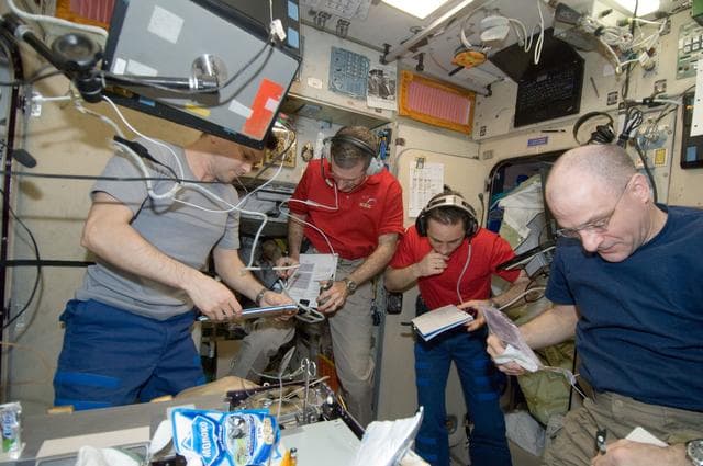 NASA image: Expedition 30 crewmembers look at crew procedures in the SM