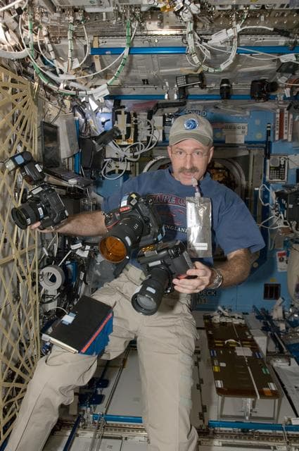 NASA image: Burbank holds cameras in the U.S. Laboratory