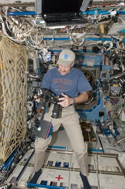 NASA image: Burbank holds cameras in the U.S. Laboratory