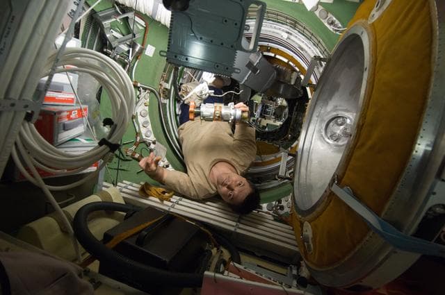 NASA image: Kononenko removes and replaces the KVD PEV