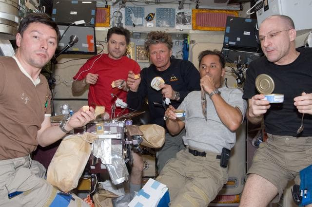 NASA image: Expedition 31 Crewmembers Share a Meal in the SM