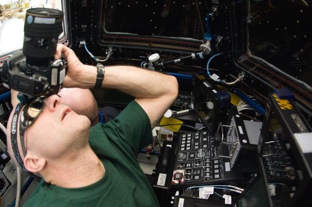 NASA image: Pettit and Kuipers photograph Dragon Flyunder Operations from the Cupola