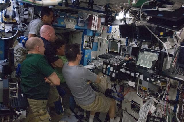 NASA image: Crewmembers watch Dragon Launch on Computer Screen