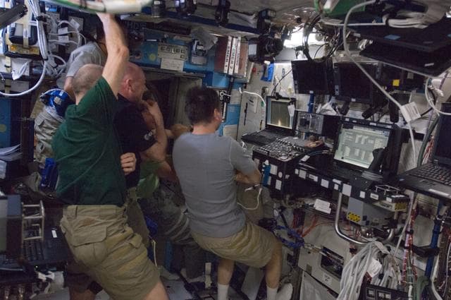 NASA image: Crewmembers watch Dragon Launch on Computer Screen
