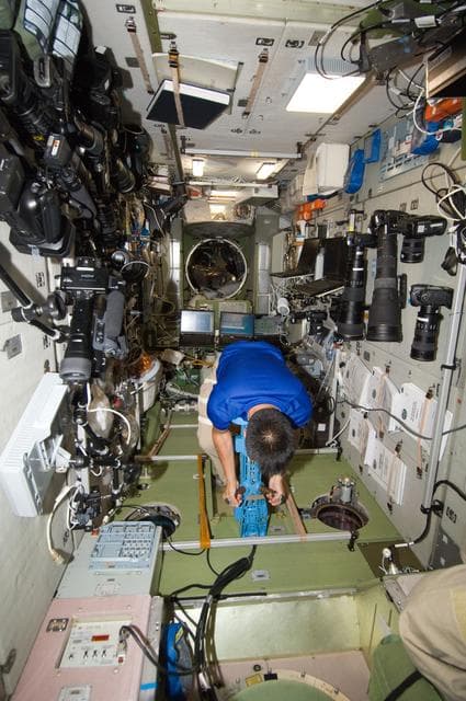 NASA image: FE Hoshide uses the IMT Mass Measurement Device in the SM