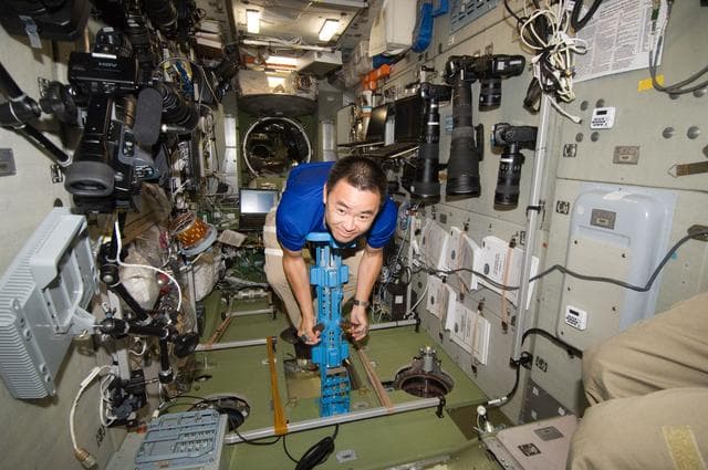 NASA image: FE Hoshide uses the IMT Mass Measurement Device in the SM