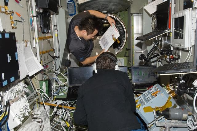 NASA image: Hoshide and Malenchenko in Service Module.