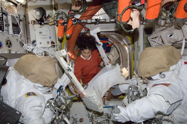 NASA image: Williams in U.S. Airlock with EVA equipment