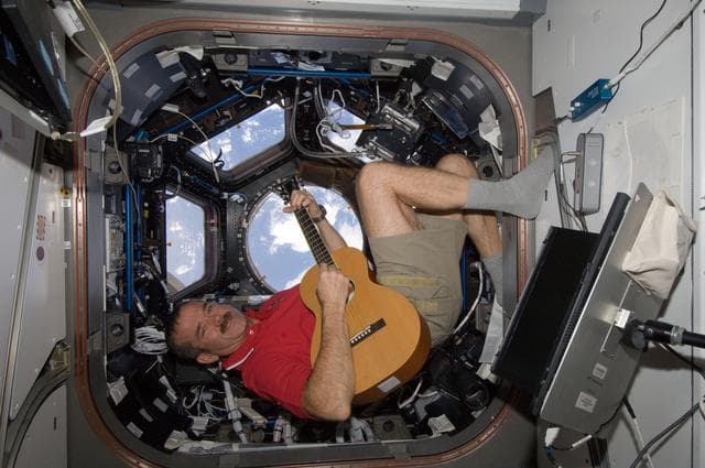 NASA image: Hadfield plays guitar in the Cupola Module