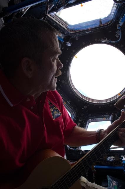 NASA image: Hadfield plays guitar in the Cupola Module