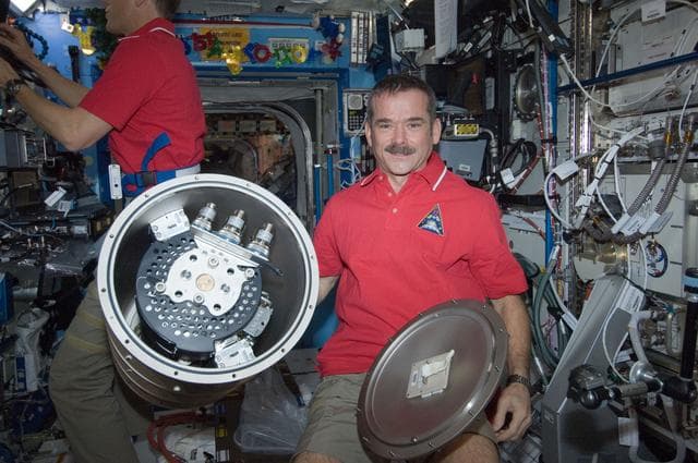 NASA image: Hadfield poses with MSL FLSS in the Node 2