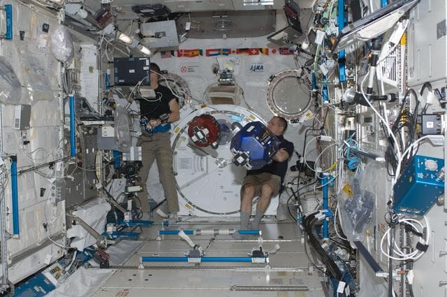 NASA image: Ford and Marshburn conducts a session of the SPHERES Experiment in the JPM