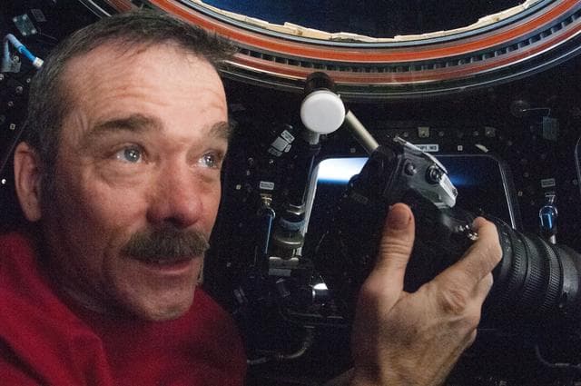 NASA image: Hadfield uses still camera in the Cupola Module