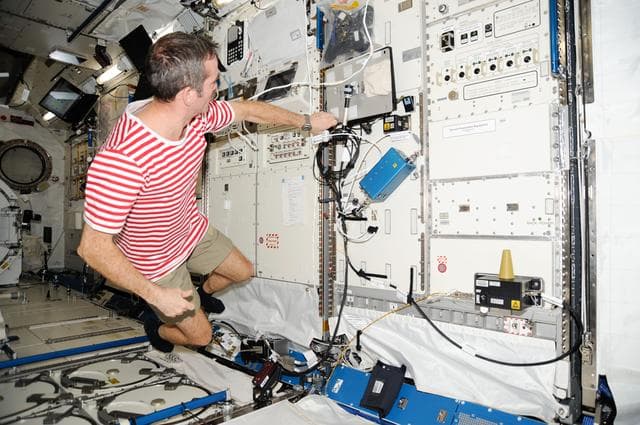 NASA image: Hadfield works at rack in the JPM