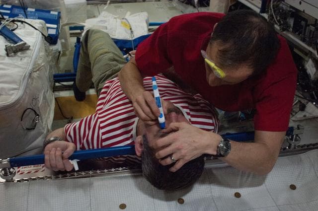 NASA image: Marshburn performs Tonometry Eye Exam on Hadfield