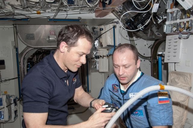 NASA image: Marshburn gives Misurkin a haircut in Node 1