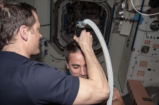 NASA image: Marshburn gives Cassidy a haircut in Node 1