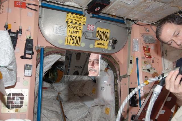 NASA image: Marshburn gives Vinogradov a haircut in Node 1