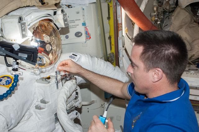 NASA image: Cassidy in Quest airlock with malfunctioning EMU