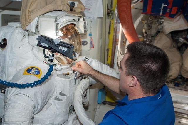 NASA image: Cassidy in Quest airlock with malfunctioning EMU