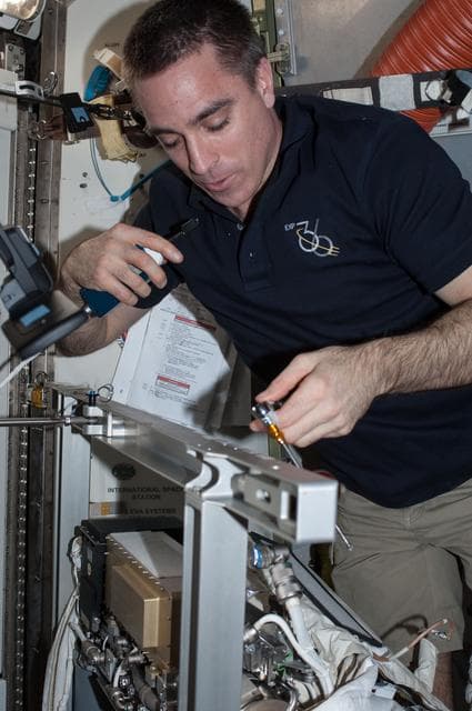 NASA image: Quest airlock with malfunctioning EMU