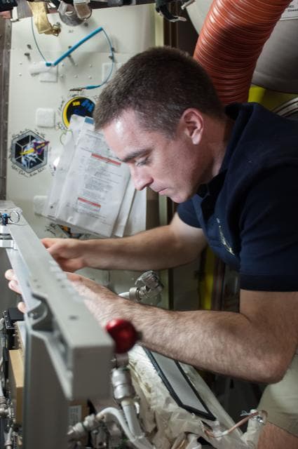 NASA image: Quest airlock with malfunctioning EMU