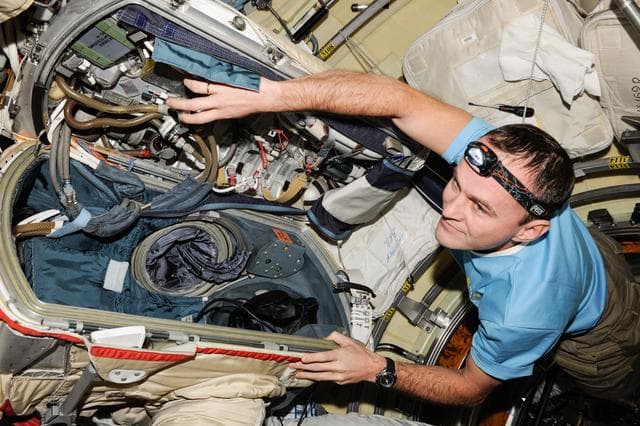 NASA image: Replacement of Orlan-MK No. 5 suit primary pump.