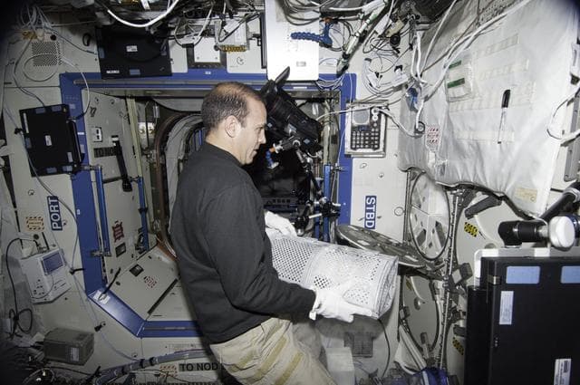 NASA image: Mastracchio removing dewar tray from MELFI