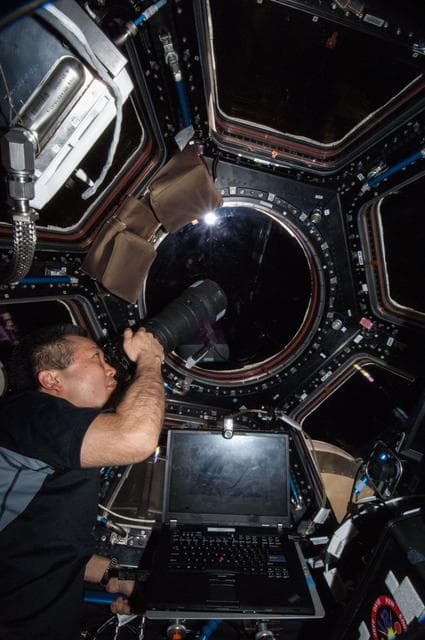 NASA image: Wakata using still camera in the Cupola Module