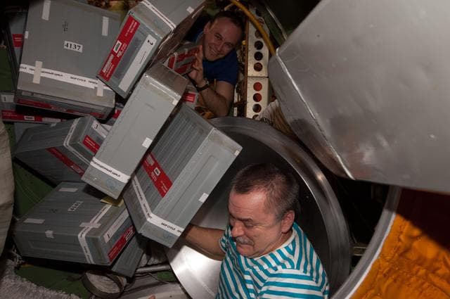 NASA image: Tyurin and Ryazanskiy unpacks Storage Containers