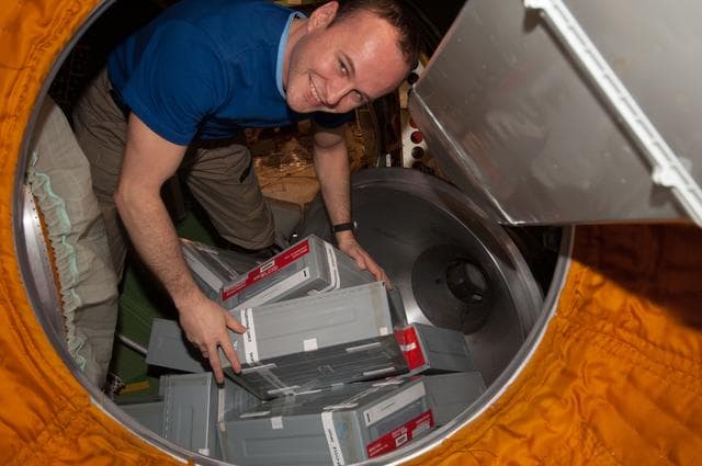 NASA image: Ryazanskiy unpacks Storage Containers