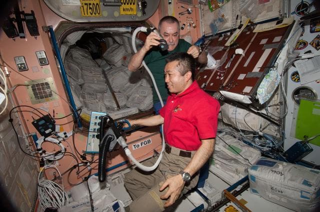 NASA image: Tyurin gives Wakata a Haircut in Node 1