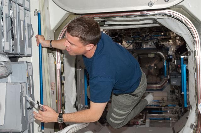 NASA image: Wiseman in hatch between U.S. Lab and Node 1