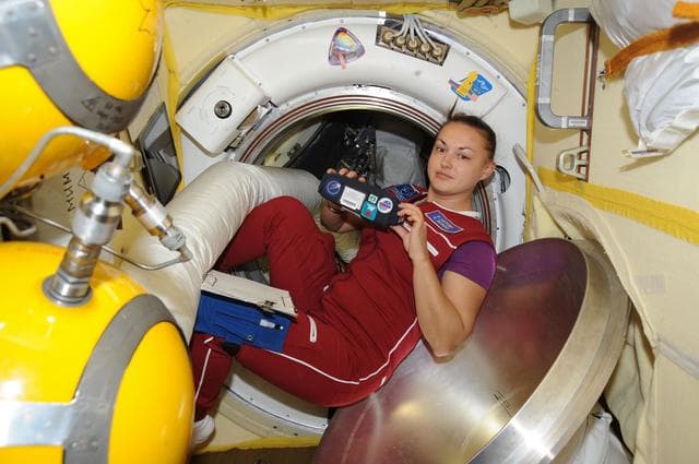 NASA image: Serova holds MATROSHKA-R, Padles Detector Kit