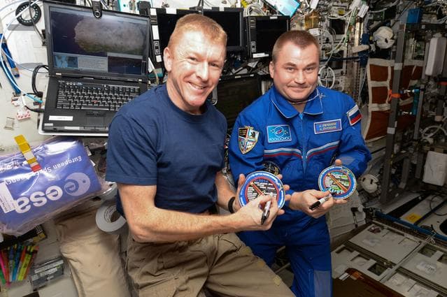 NASA image: Peake and Ovchinin holding Astronaut Patches