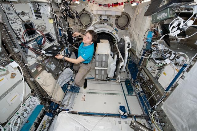 NASA image: Astronaut Anne McClain works inside the Kibo lab module