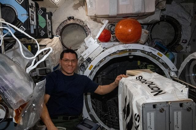 NASA image: Astronaut Frank Rubio installs the NanoRacks CubeSat Deployer