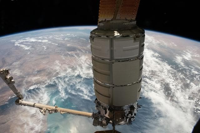 NASA image: The Cygnus space freighter in the grip of the Canadarm2 robotic arm